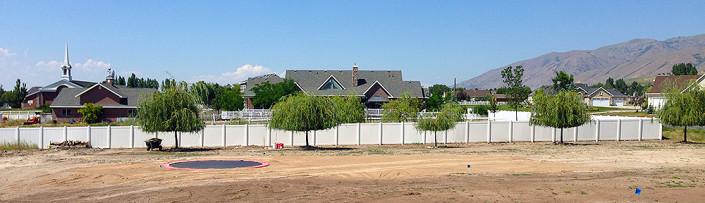 White Vinyl Privacy Fence Bordering Property